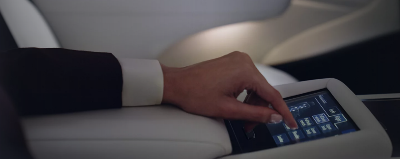 A person using the touchscreen feature in the Lexus LS. 