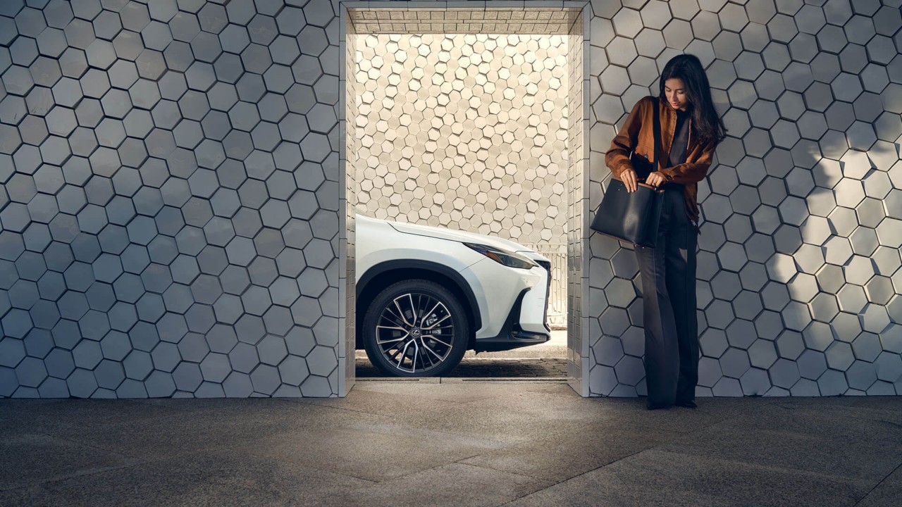 A woman standing by the Lexus NX 