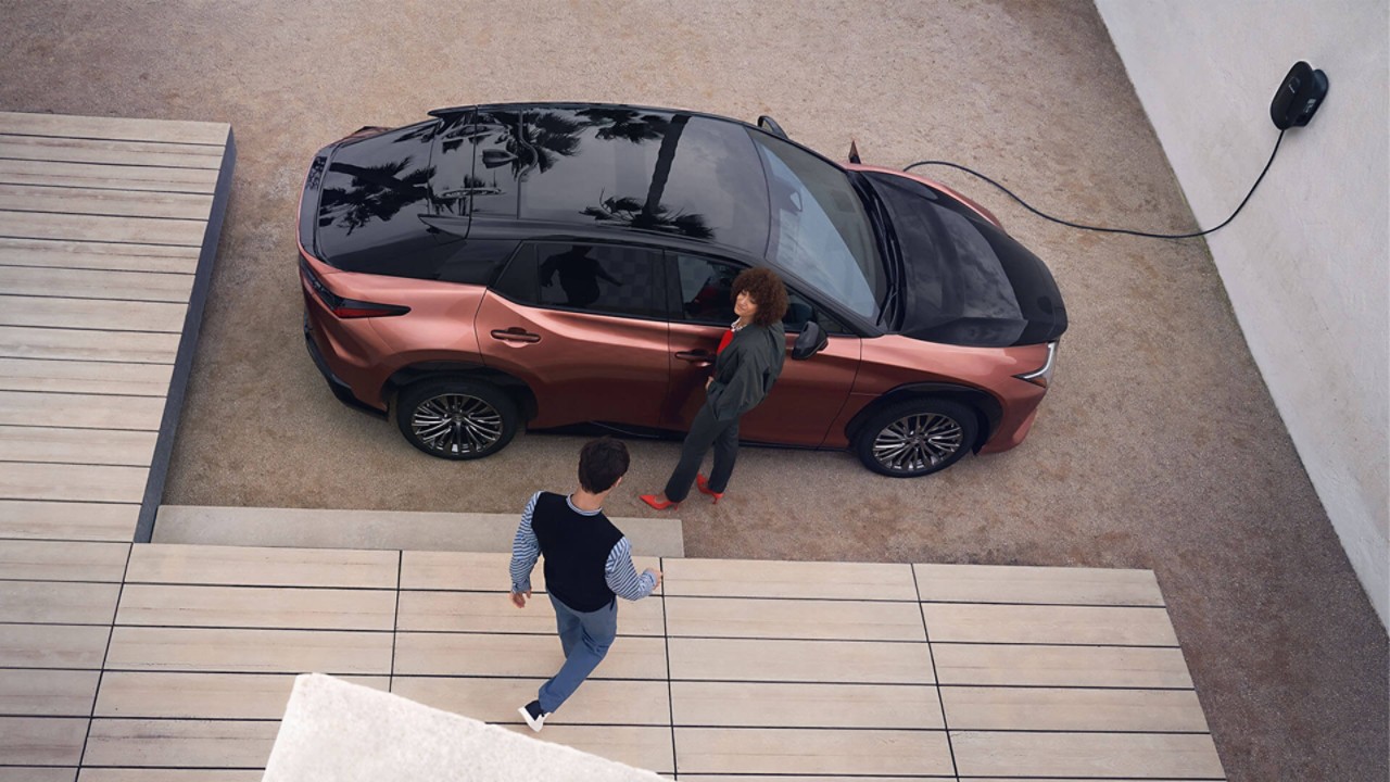A man plugging in a charger into a Lexus UX 300e