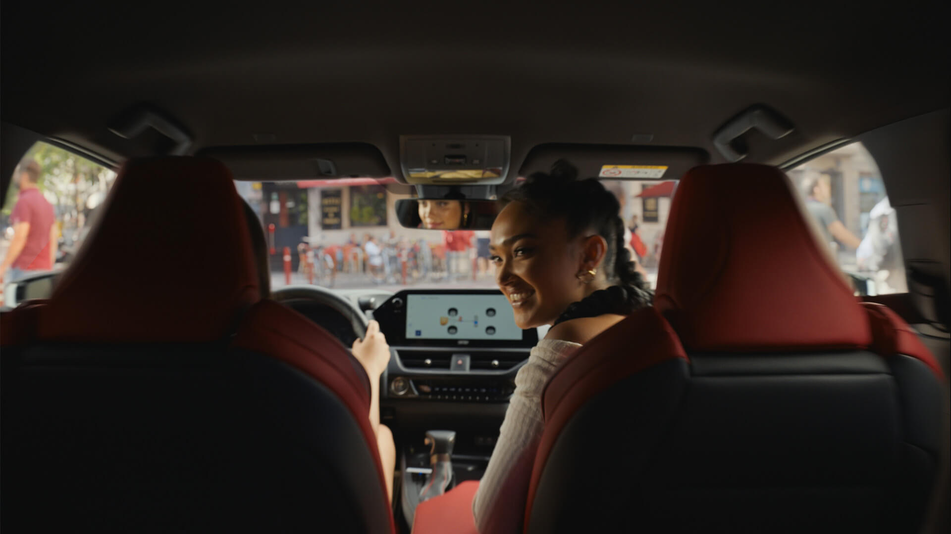 Joy Crookes sat in the front passenger seat in a Lexus UX