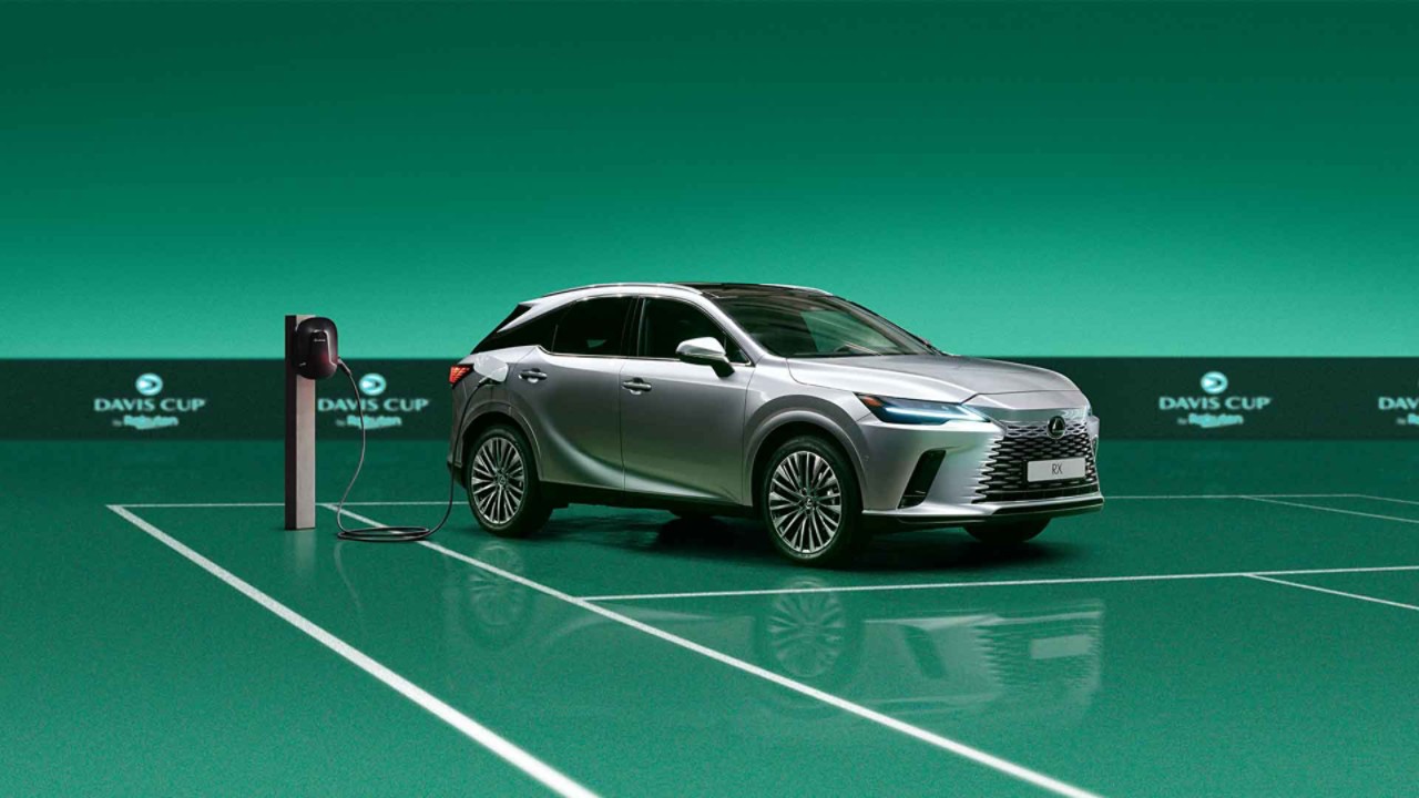 Lexus RX plugged into a charging tower on a Davis Cup tennis court